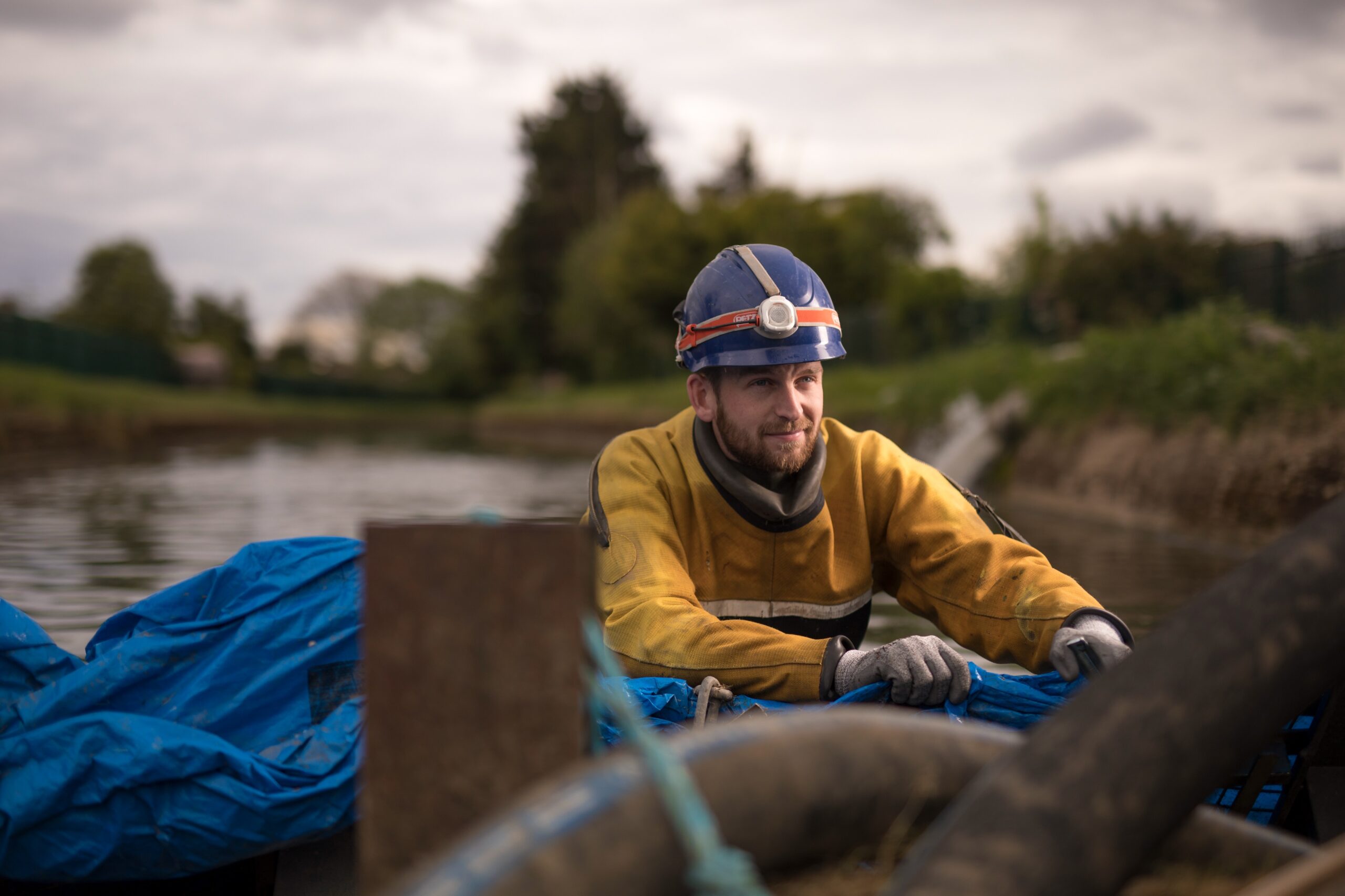 HighWater operative working beside a temporary dam system in a live water environment