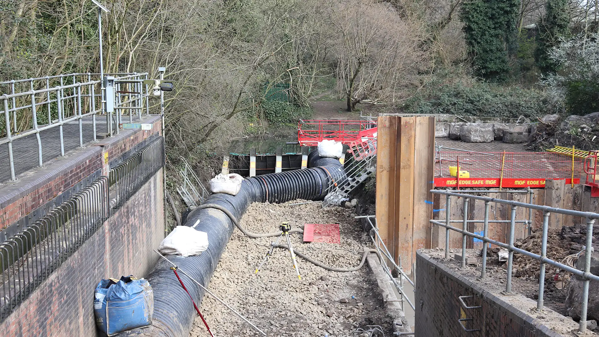 Temporary overland flow diversion pipeline routing water safely around an active construction site to keep work areas dry.
