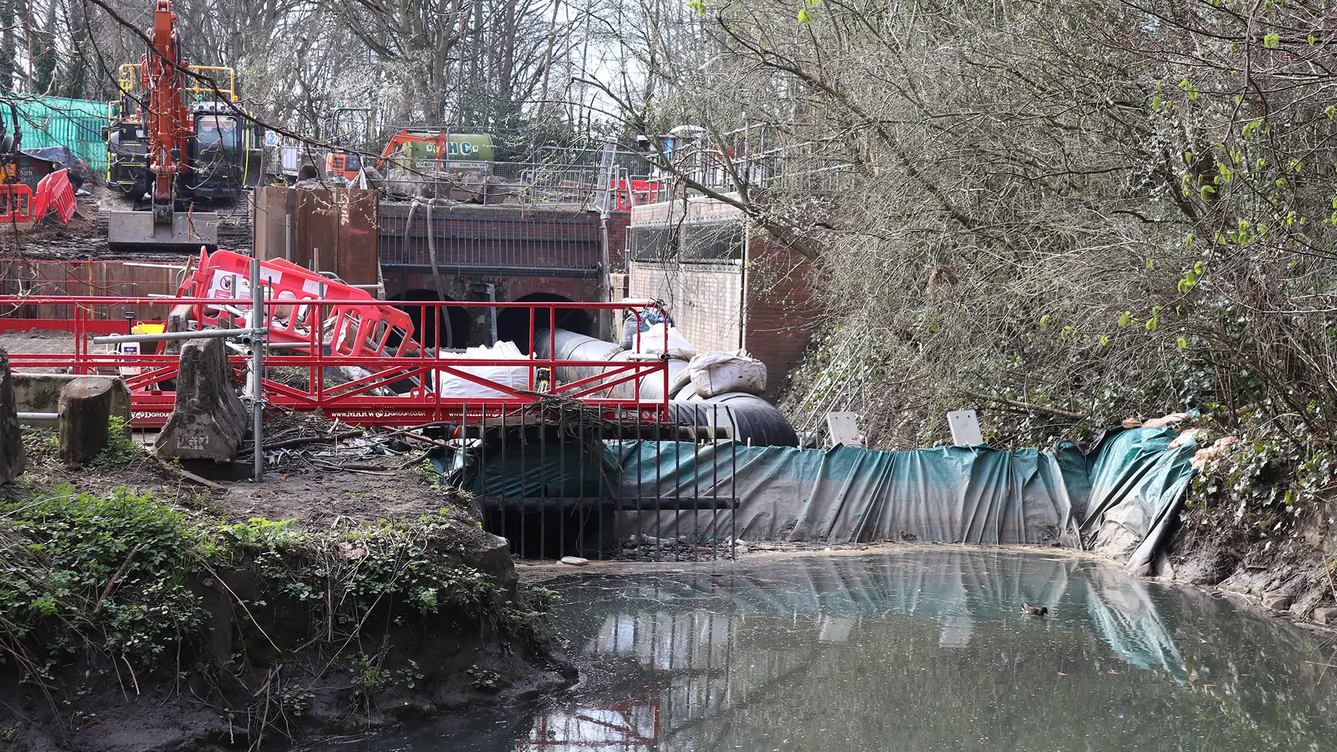 Temporary flow diversion system bypassing a watercourse during engineering works using large diameter pipelines and temporary cofferdam protection.