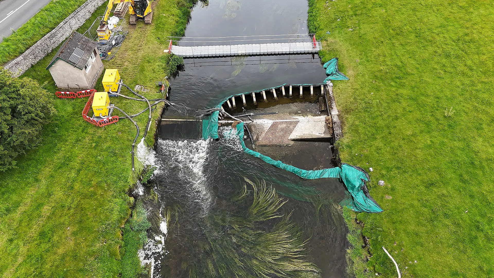 Aerial view of a frame dam with over pumping equipment installed for environmental protection