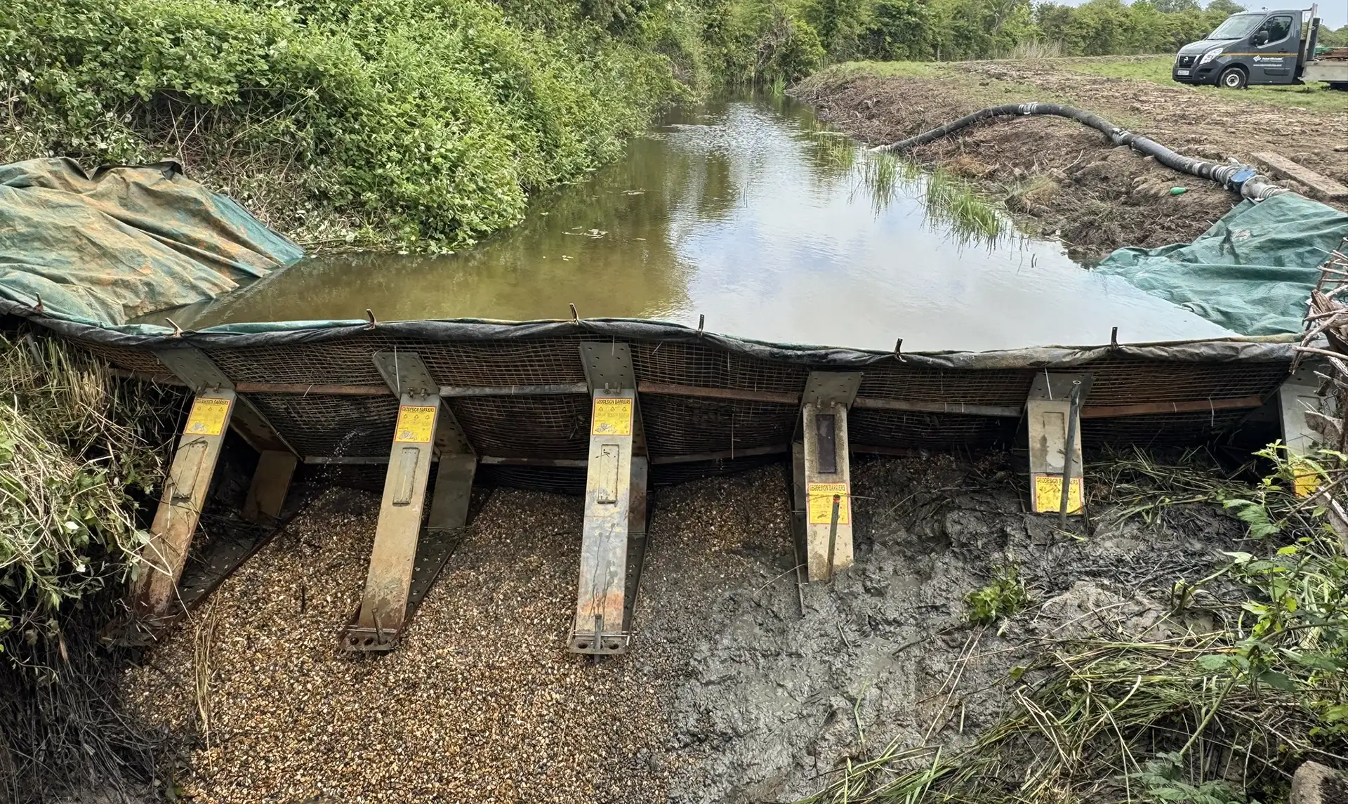 High Water engineered Frame Dam installed across a watercourse to retain water and create a safe, dry working area for construction and maintenance.