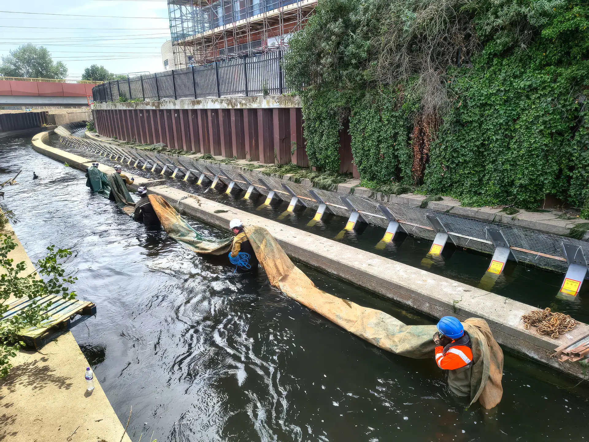 High Water’s specialist in-water team installing a temporary water control system within a live watercourse to create safe working conditions.