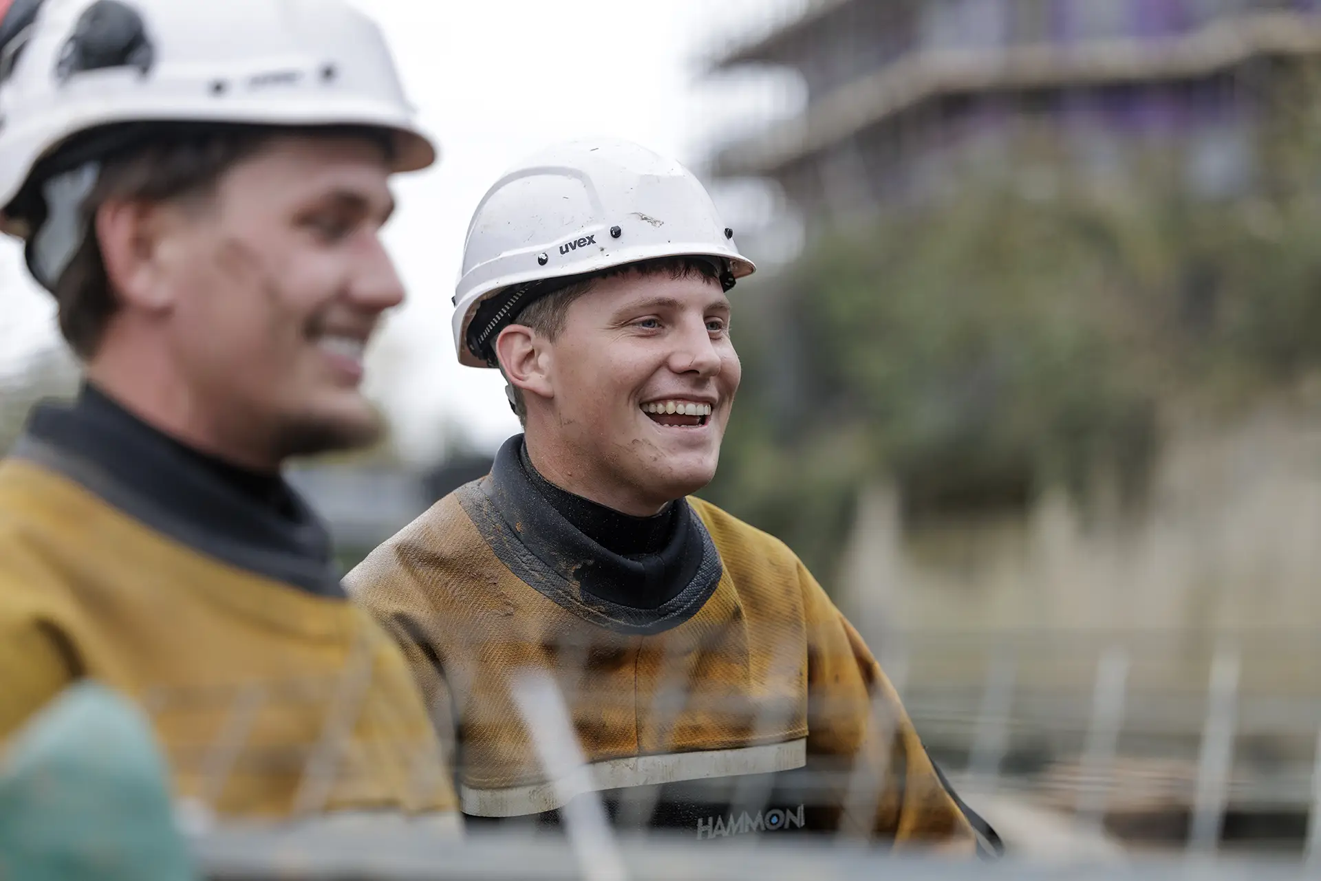 Specialist in-water operatives wearing protective equipment and safety helmets on site