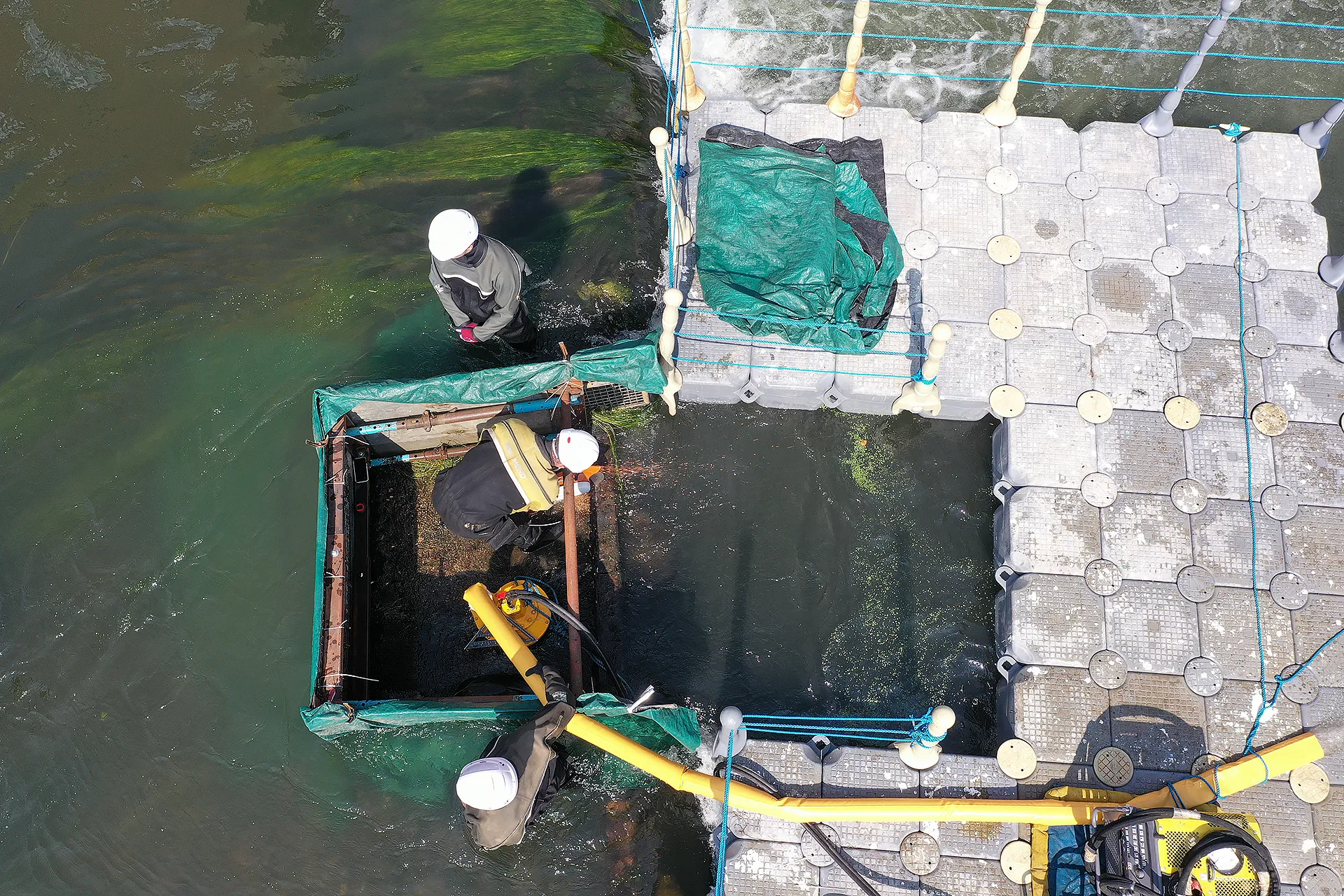 Engineers working within a temporary water control enclosure to install and commission in-channel infrastructure.