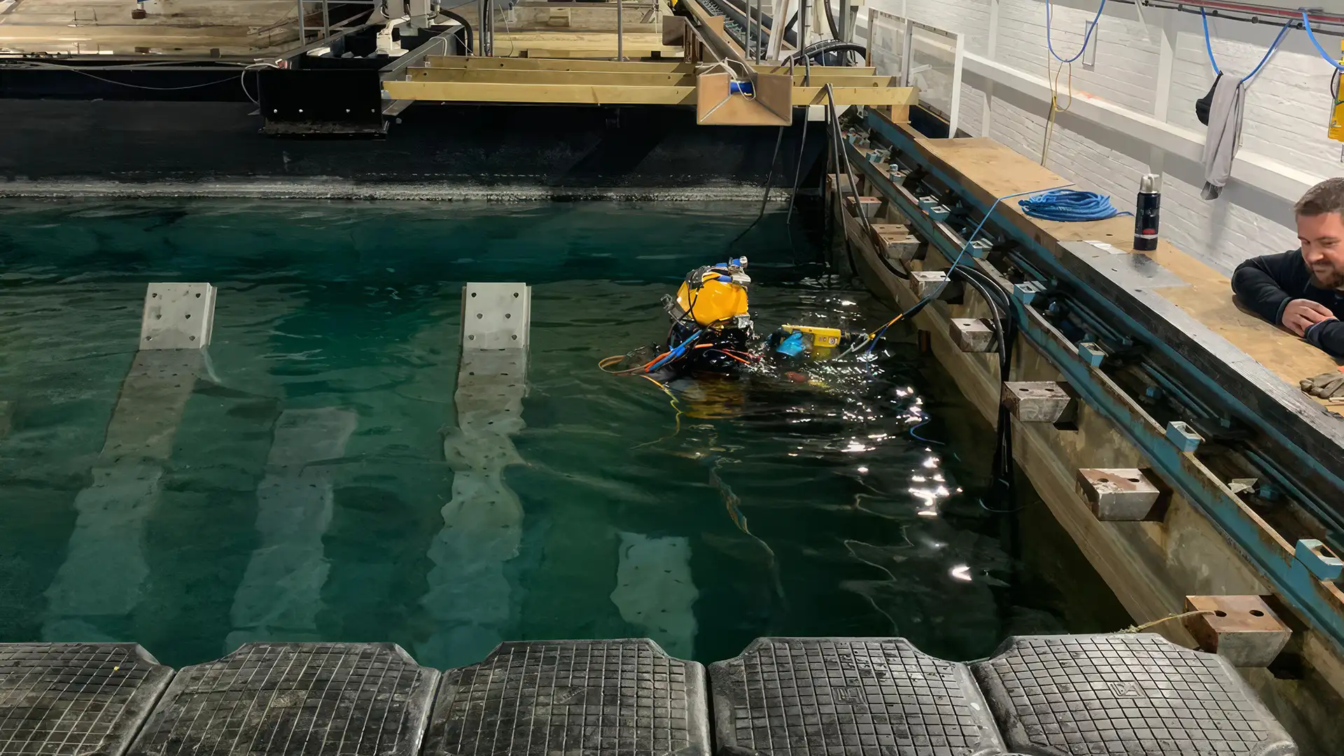 In-water operative using specialist diving equipment in an indoor test tank